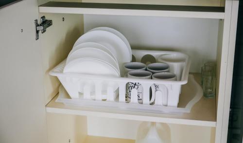 a shelf with dishes and other items in a cabinet at Scandidim Lutsk in Luts'k