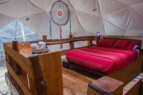 a bedroom with a bed in a tent at Cabañas Ensenada Bosque Nativo in Ensenada