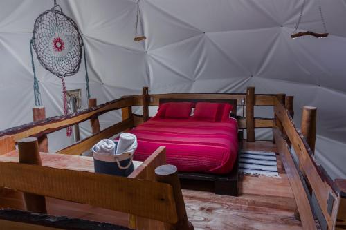 a bedroom with a bed in a tent at Cabañas Ensenada Bosque Nativo in Ensenada
