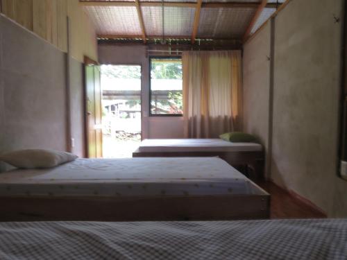 Ένα ή περισσότερα κρεβάτια σε δωμάτιο στο Poponjoche Lodge Caño Negro