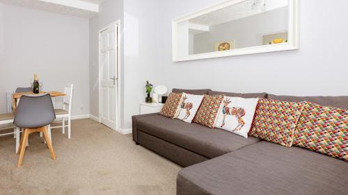 a living room with a couch and a table at Stirling Central Apartment in Stirling