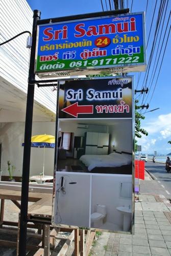 a sign for a store with a small refrigerator at Sri Samui in Nathon