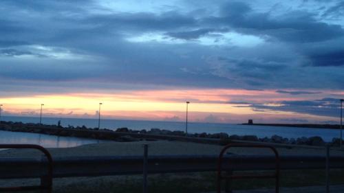 a sunset over the water with a road and street lights at Casa Vacanze Chiara in Terrasini