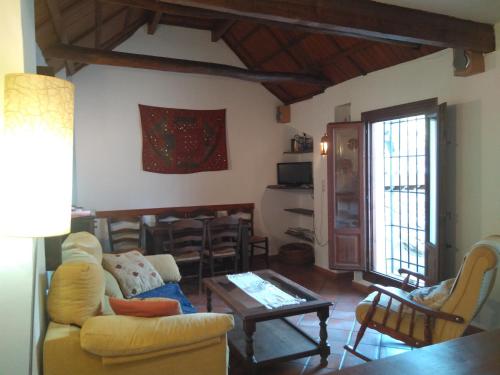 a living room with a couch and a table at Casa-Mirador La Alhacena in Granada