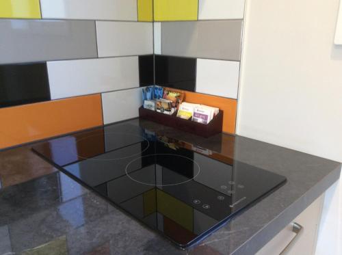 a glass counter top in a room with colorful walls at BigSky Motels in Omarama