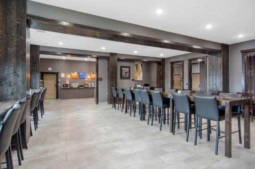 a dining room with a long table and chairs at Comfort Inn & Suites in North Battleford