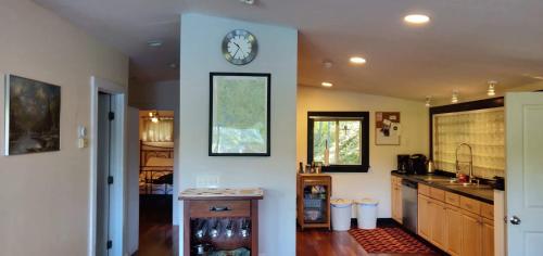 a kitchen with a clock on a wall at Lake side oasis in Freedom