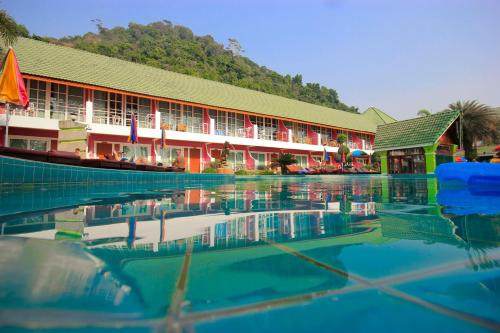 a hotel with its reflection in the water at Cookies Hotel in Ko Chang