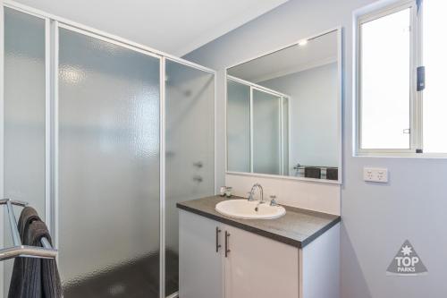 a bathroom with a sink and a shower at Mandurah Caravan and Tourist Park in Mandurah