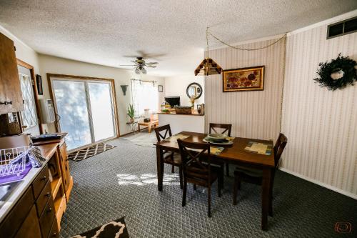 a kitchen and dining room with a table and chairs at The Pines Country Inn in Newcastle