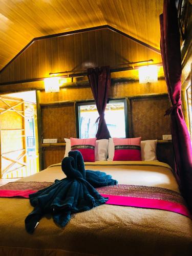 a person laying on a bed in a room at Khao Sok Blue Mountain in Khao Sok National Park