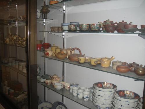 a shelf filled with lots of pots and pans at Hotel Suehiro in Matsumoto