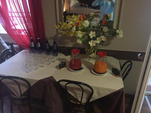a table with wine bottles and glasses on it at Crotto dei Pescatori in Lezzeno