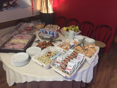 a table with a white table cloth with food on it at Crotto dei Pescatori in Lezzeno