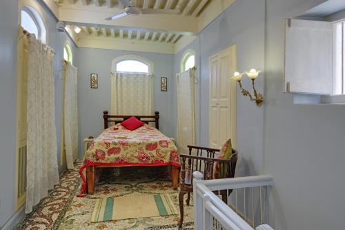 a small room with a table and a staircase at French Haveli in Ahmedabad