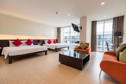 Postel nebo postele na pokoji v ubytování Hotel J Pattaya