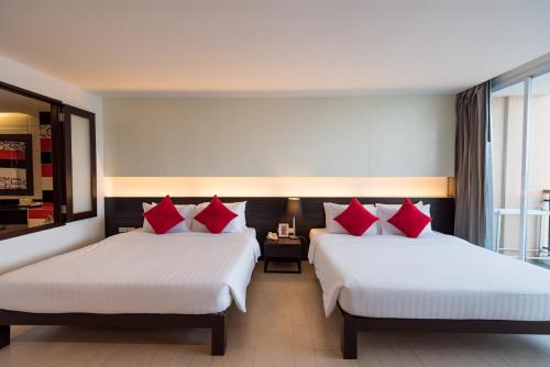 Postel nebo postele na pokoji v ubytování Hotel J Pattaya