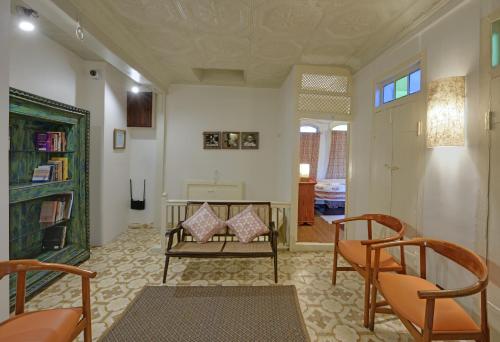 a living room with two chairs and a table at French Haveli in Ahmedabad