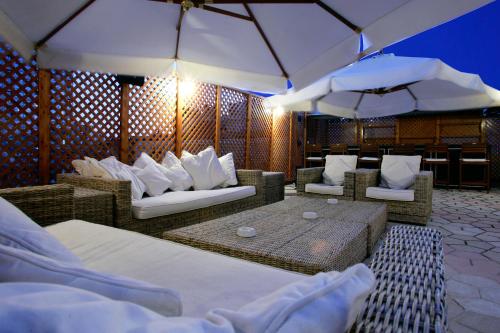 a room with couches and tables and umbrellas at The Mayflower Hotel in Beirut