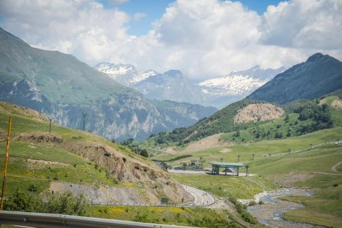 a road in a valley with mountains in the background at Tierra de Biescas in Biescas