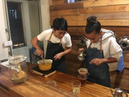 two women in a kitchen preparing food at Old Man Captain in Tainan
