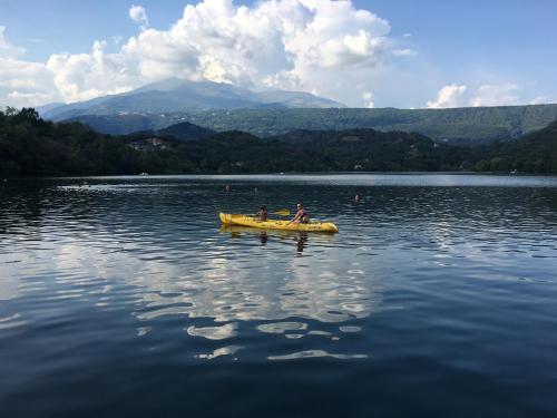two people in a yellow boat on a lake at La mansarda di Orni in Ivrea