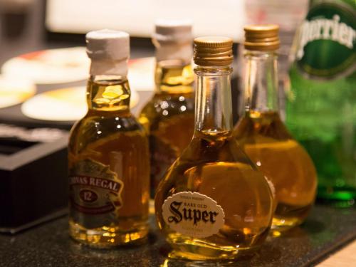 a group of four bottles of honey on a counter at Hotel Shiki Utsubo Park in Osaka