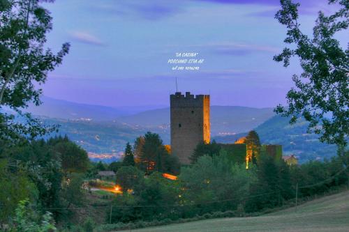 a castle sitting on top of a hill at night at La Casina in Stia