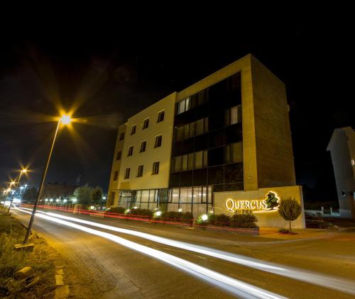 a building on a street at night with streaks of lights at Hotel Quercus in Međugorje