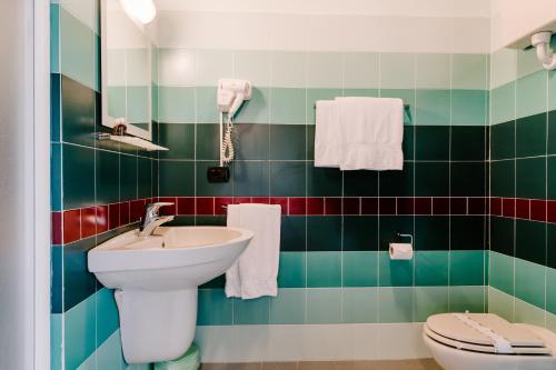 a bathroom with a sink and a toilet at Country House Santa Maria Maddalena in Budrio
