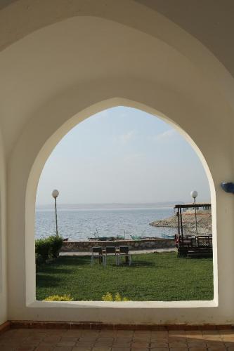 an arch in a building with a view of the ocean at New Panorama Resort in Fayoum Center