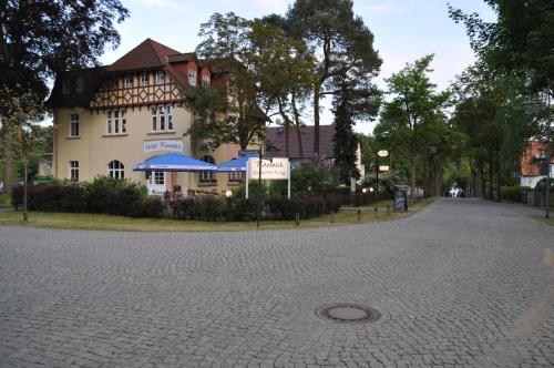 a cobblestone street in front of a building at Hotel & Restaurant Raueneck in Bad Saarow
