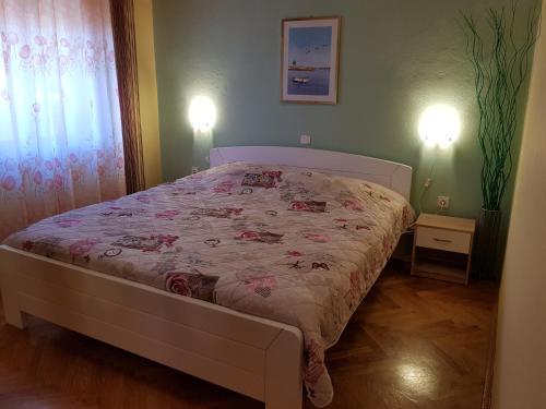 Katil atau katil-katil dalam bilik di Diana Apartman
