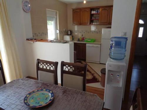 a kitchen with a table with a container on top of it at Zelena Maslina in Bar