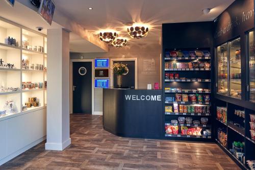 a store with a welcome counter and shelves of products at Singel Hotel Amsterdam in Amsterdam