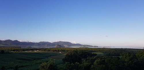 a view of a golf course with mountains in the background at Résidence BelKay - Sur La Baie in Ducos