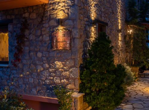 a stone building with a sign on the side of it at Ξενώνας Οντάς και Spa in Arachova