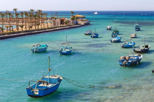 a group of boats sitting in the water at Meraki Resort - Adults Only in Hurghada