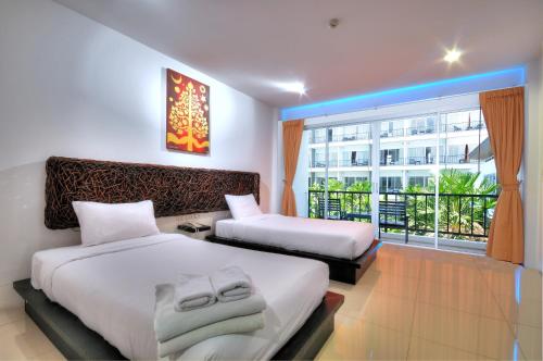 מיטה או מיטות בחדר ב-BS Residence Suvarnabhumi - SHA Extra Plus