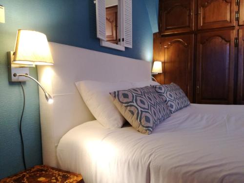 a bedroom with a bed with a pillow on it at La Bergerie de Lives in Namur