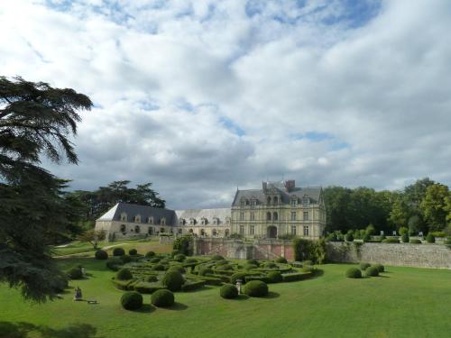 a large castle with a green yard with bushes at Château De La Bourdaisière in Montlouis-sur-Loire