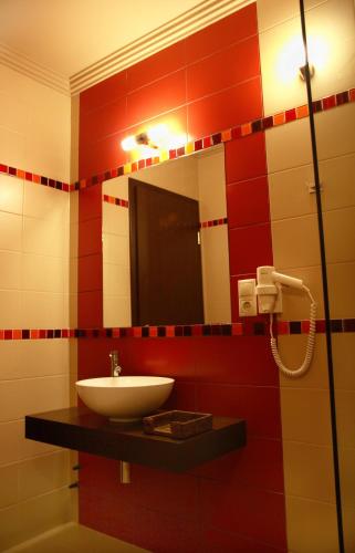 a bathroom with a sink and a mirror at Zala Aranya Panzió in Zalakaros