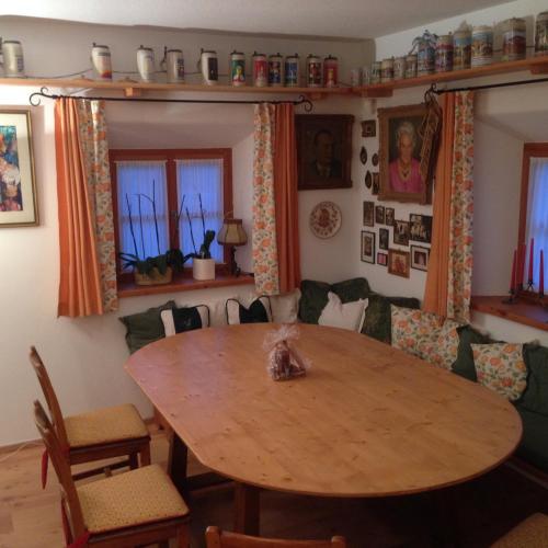 a dining room table with a cat sitting on top of it at Schusterhof in Bergen