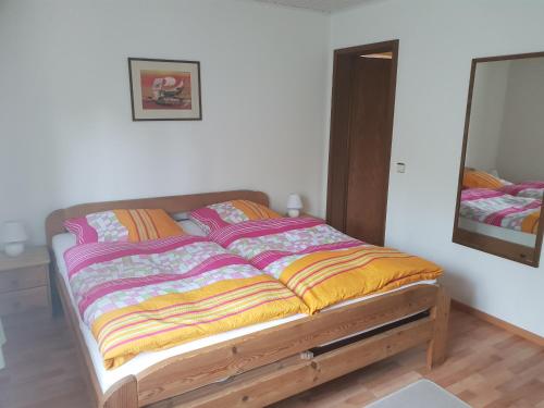 a bed in a bedroom with a mirror at Ganerb in Dudenhofen