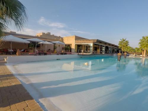 a large swimming pool with a person standing in it at Masseria & Spa LuciaGiovanni in Lecce