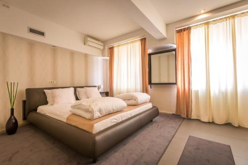 Un dormitorio con una cama con almohadas blancas. en HostGost at BAMS (Private Spa included) en Belgrado
