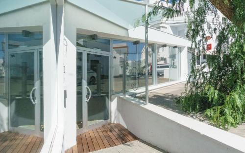 a facade of a building with glass doors at TAKE SURF Hostel Conil in Conil de la Frontera