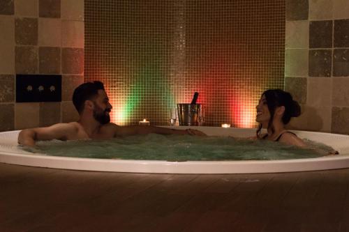 a man and a woman in a bath tub at Hotel Centrale in Gambarie dʼAspromonte