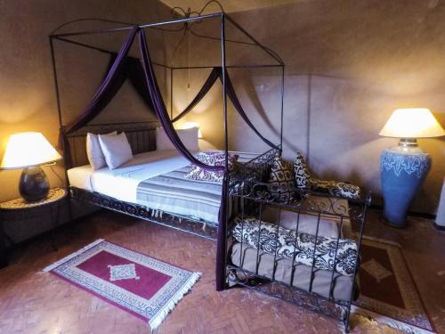 a bedroom with a canopy bed and two lamps at Masseria & Spa LuciaGiovanni in Lecce