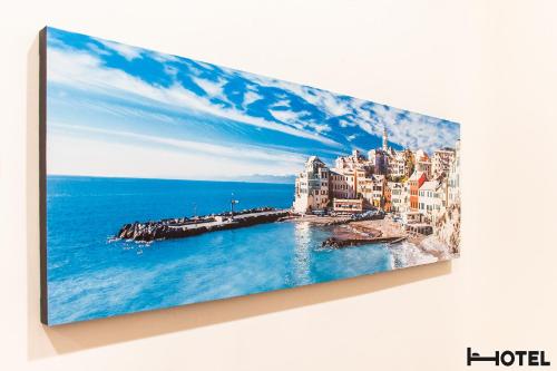a painting of a city over the water at Hotel Youri Il Magnifico in Genova